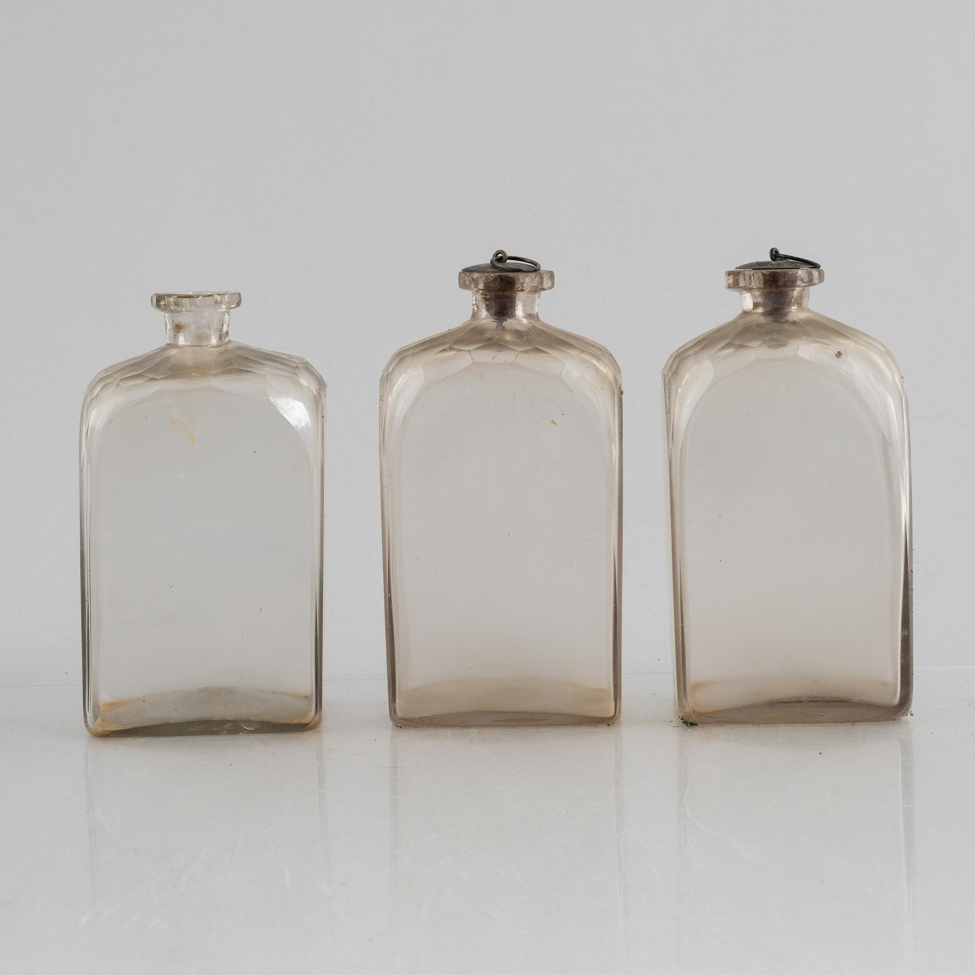 A wooden box with three glass flaska, first half of the 19th century.