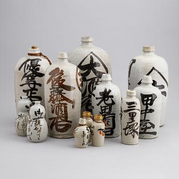 A group of twelve Japanese white glazed ceramic sake bottles, first half of the 20th century and mid 20th century.