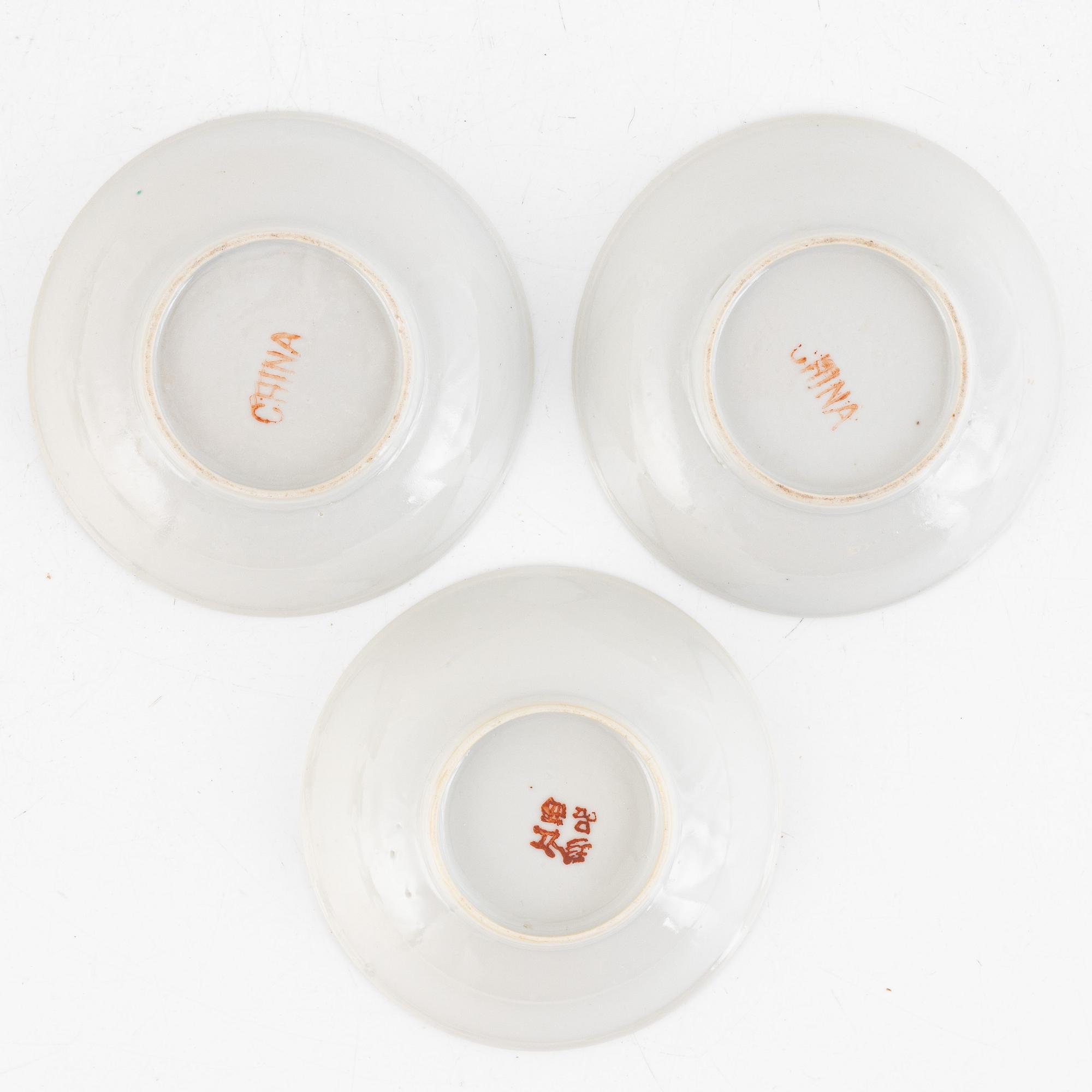 A group of three Chinese enamelled porcelain cups with covers and stands, three small dishes, 20th century.