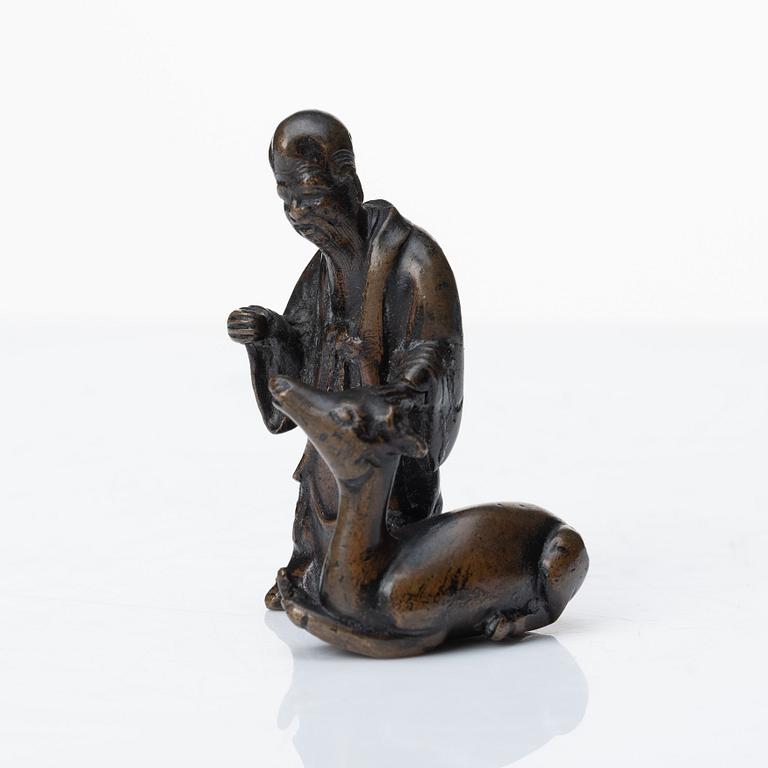 A bronze scultpure of the God of Longevity Sholaou and his deer, Qing dynasty, 18th Century.