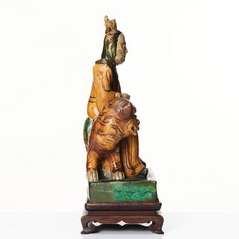 A green and yellow glazed figure of a dignitary and a tiger, Ming dynasty (1368-1644).