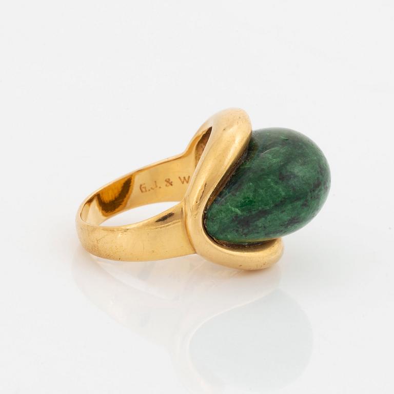 A Georg Jensen & Wendel ring in 18K gold set with a green and black stone.