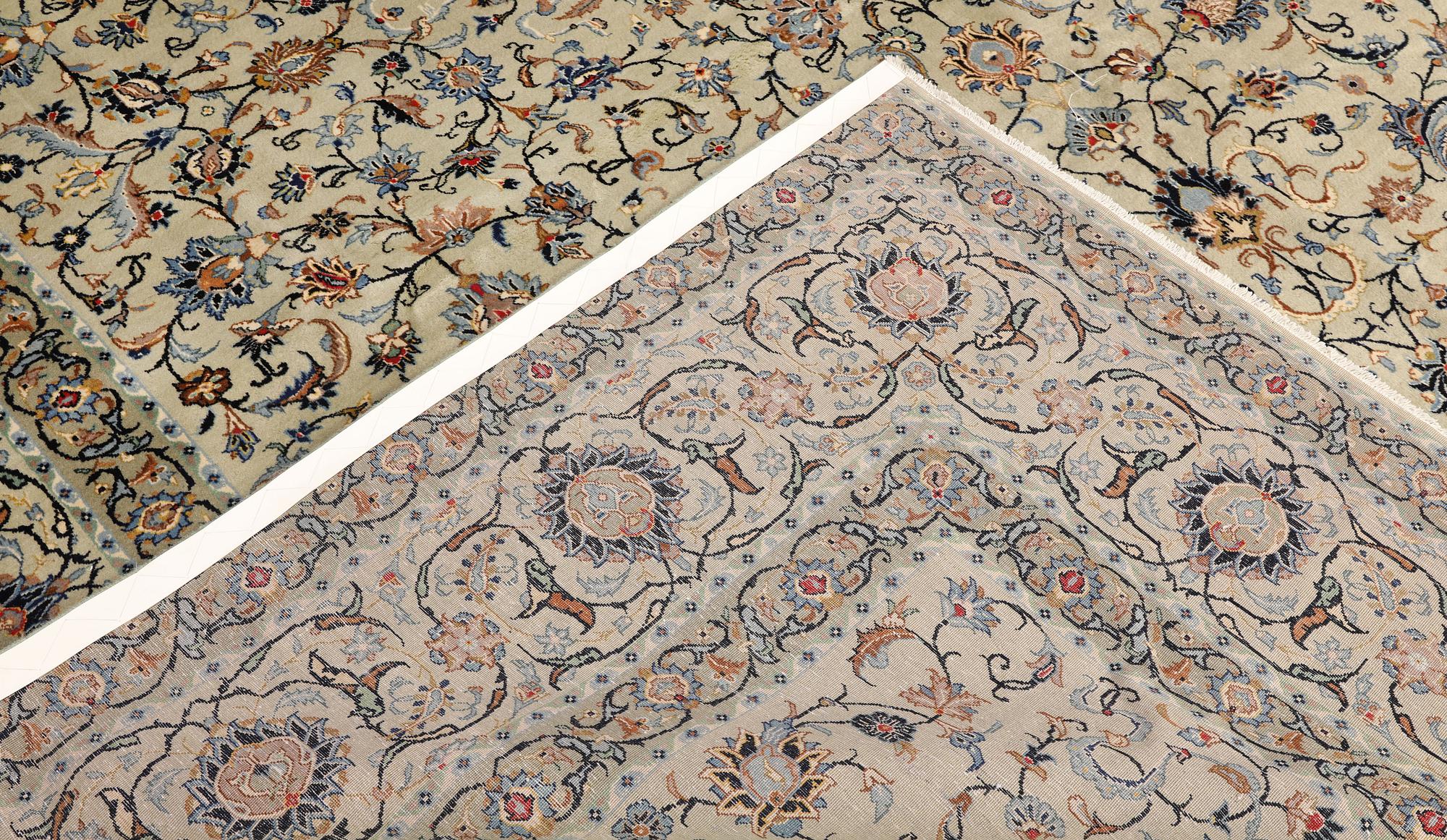 A Keshan carpet, signed, approx. 410 x 323 cm.