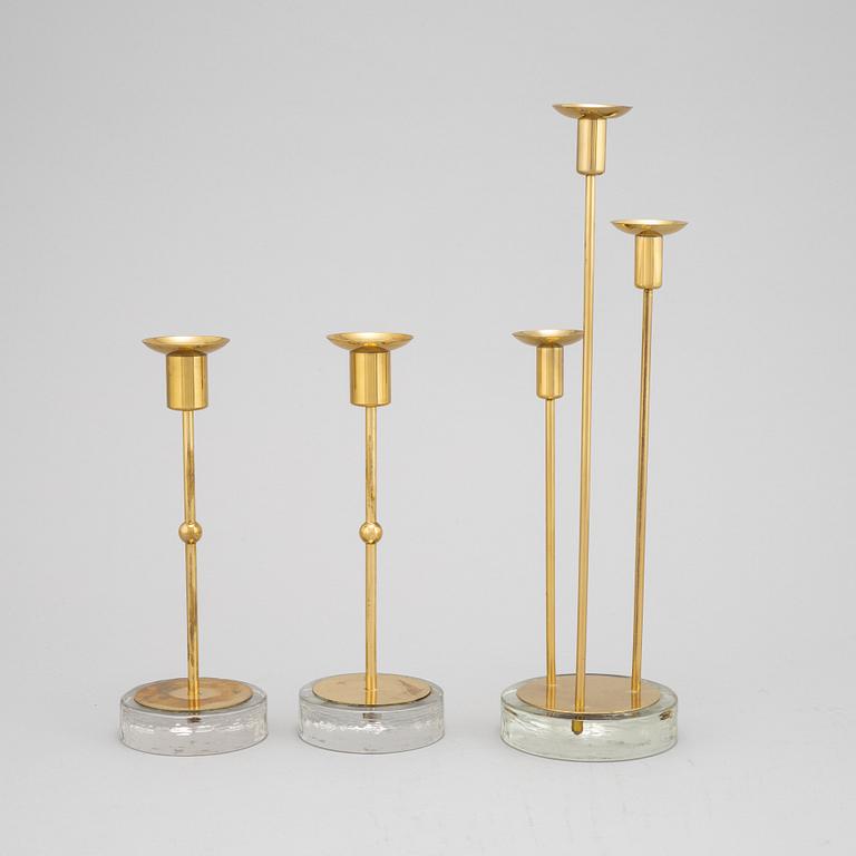 Gunnar Ander, a set of three brass and glass candlesticks from Ystad Metall.