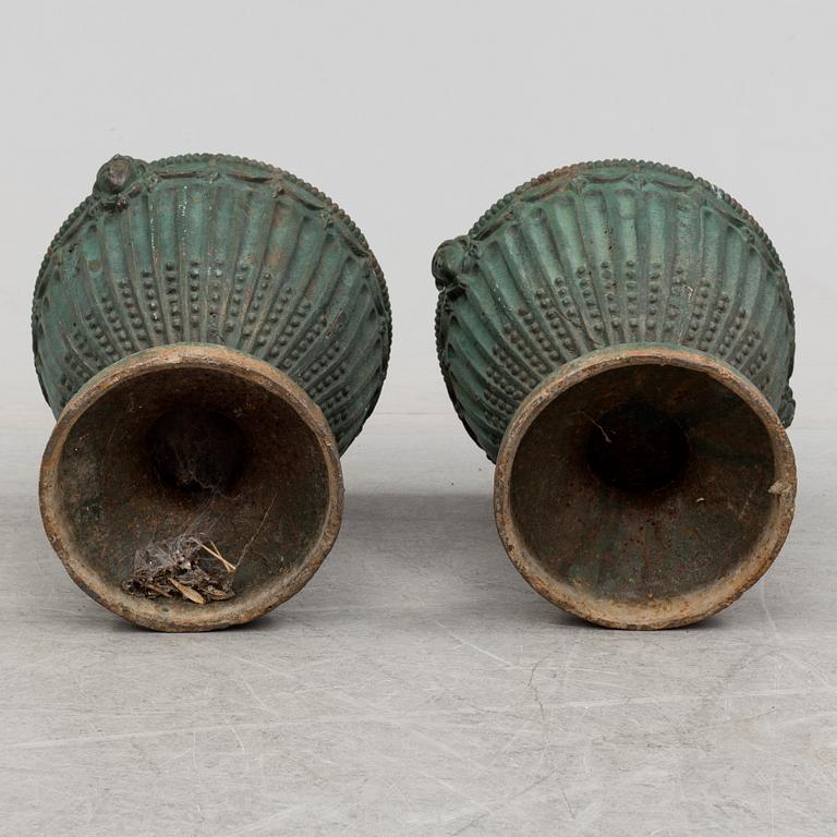 A pair of early 20th century iron garden urns.