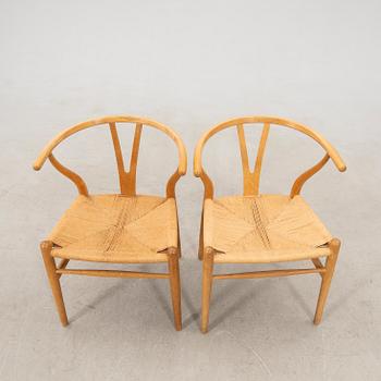 Hans J. Wegner, chairs, a pair of "The Wishbone Chair", model CH-24, Carl Hansen & Søn, Denmark.