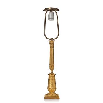 An gilded Empire table lamp.