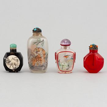 Four Chinese snuff bottles in glass and stone, 20th century.