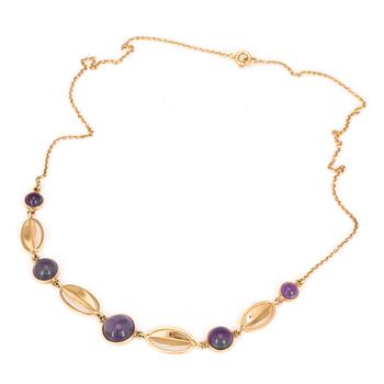 A necklace with round, cabochon-cut amethysts.