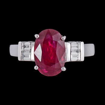 1011. A ruby, 3.02 cts, and emerald cut diamond ring.