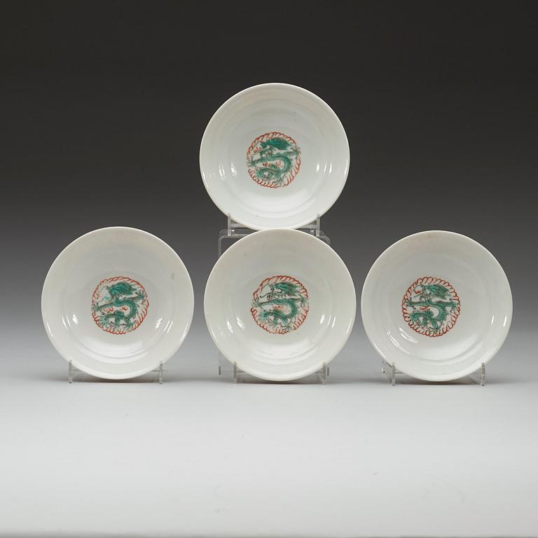 A set of four yellow ground famille rose bowls with covers, early 20th century with Guangxu six character mark in red.