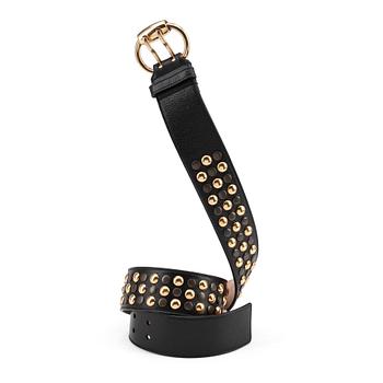 274. GUCCI, a black leather belt with goldcolored and patinated decor.