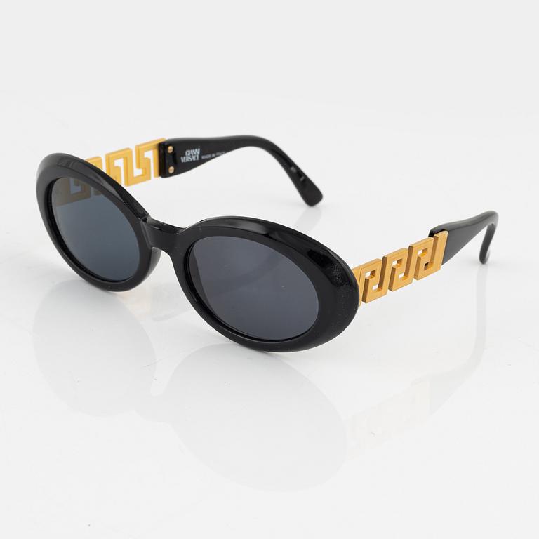 Gianni Versace, a pair of black and gold sunglasses.