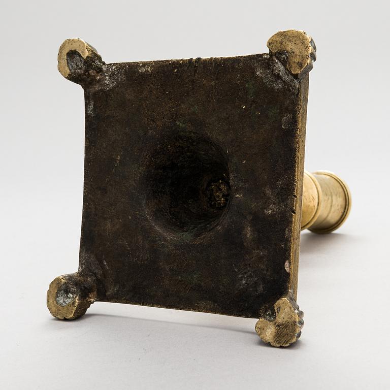 A late 17th century Spanish brass candlestick.