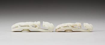 Two pale green nephrite garment hooks, Qing dynasty.