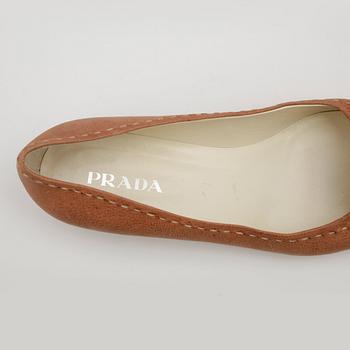 PRADA, a pair of beige leather shoes.