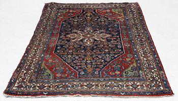 An oriental, semi-antique rug, c. 195 x 130 cm.