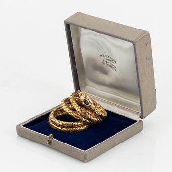 An 18K gold snake bracelet.