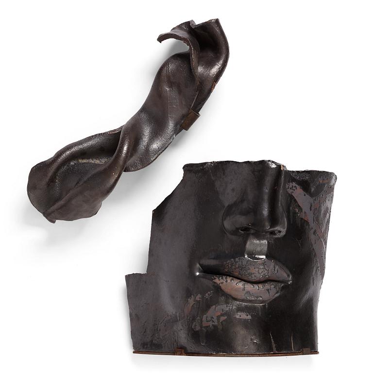 Hertha Hillfon, a black glazed stoneware wall sculpture in two parts of a face and a sky, executed in her own studio, Stockholm 1960s.