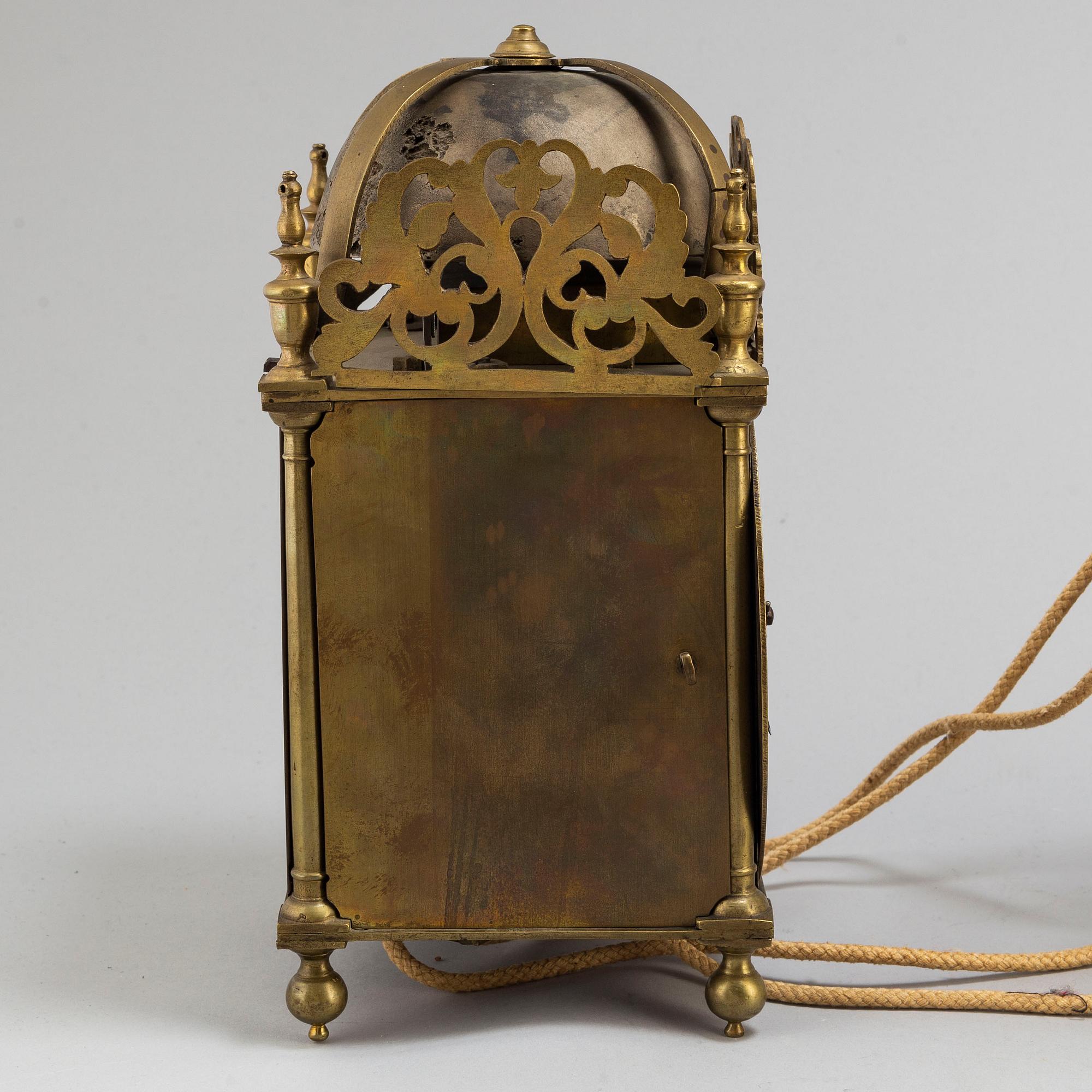 A late 17th or early 18th century lantern clock signed J Windmills London.