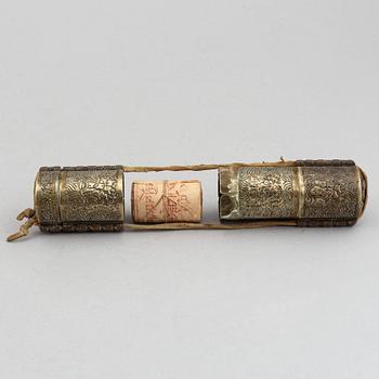 A Tibetan prayer roll and a metal roll with compartments with prayer rolls, 19th Century.