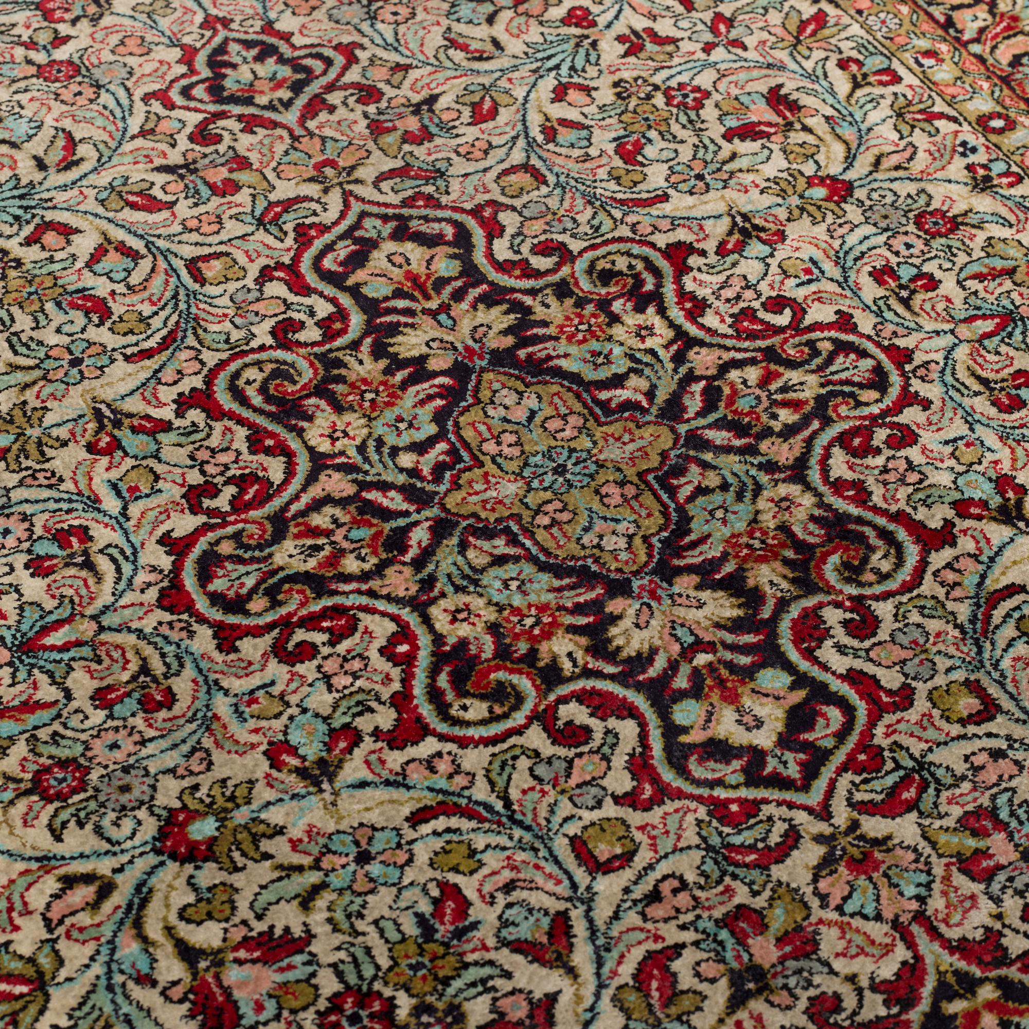 A silk Qum rug, around 114 x 80 cm.