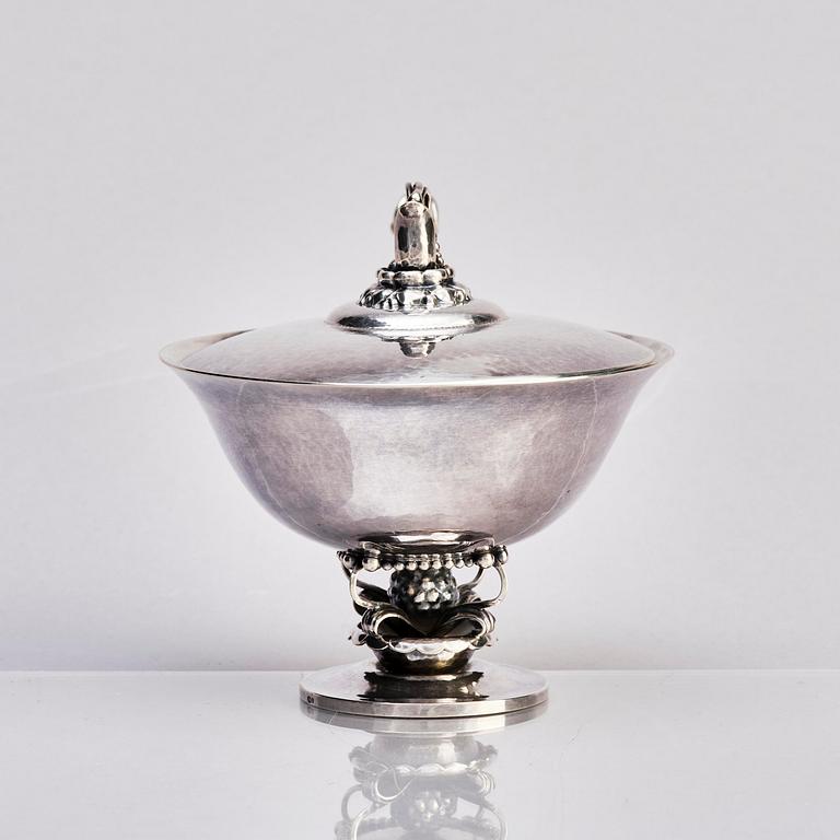 Georg Jensen, a silver bonbonnière and a sprinkle spoon, Copenhagen 1919-1927, design no 234, spoon design no 74.