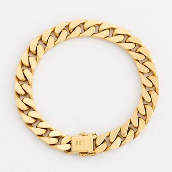 18K gold and brilliant cut diamond curb link bracelet.