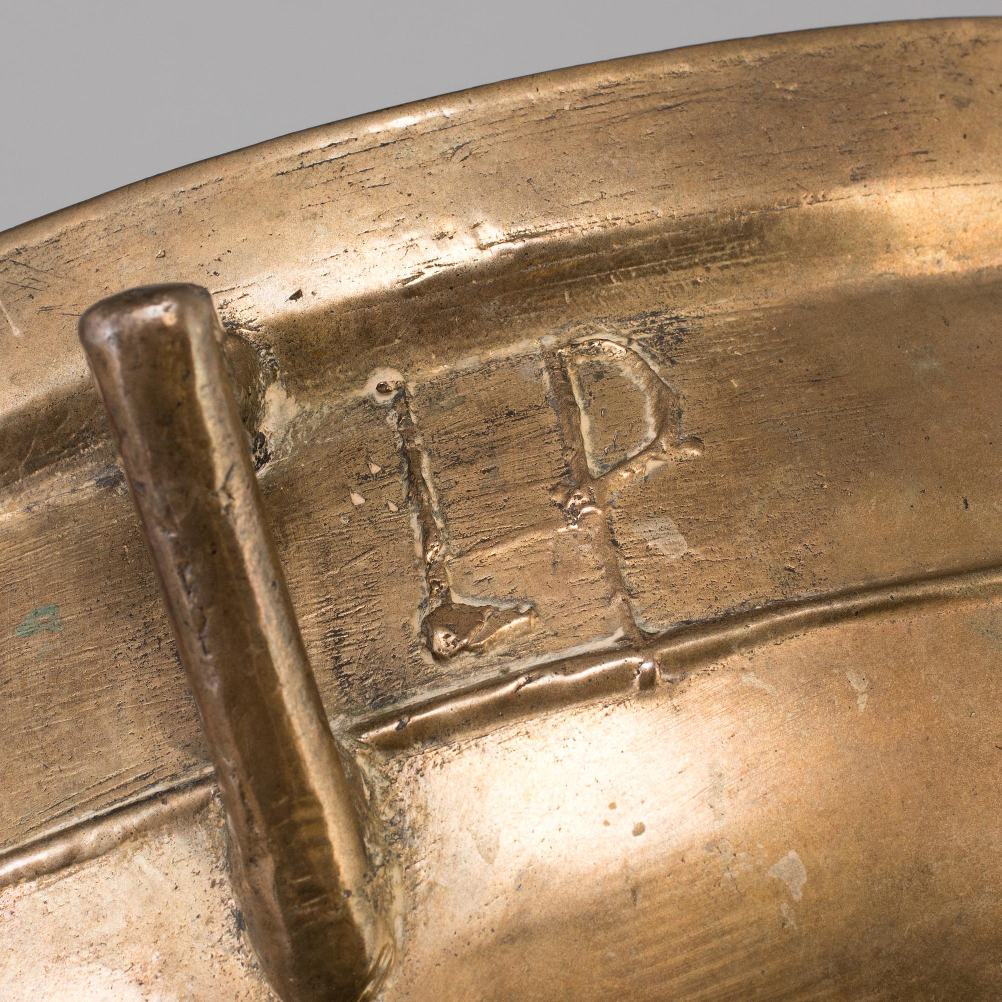 A 19th century brass cauldron.