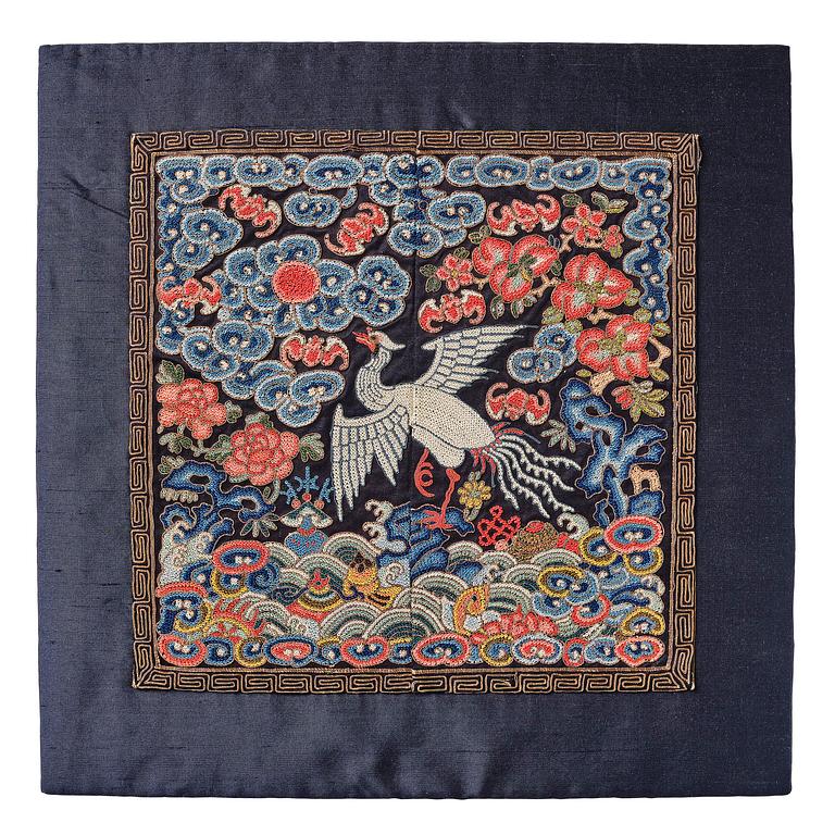 An embroidered civil official's rank badge with a silver pheasant, Qing dynasty, Tongzhi period (1862-1874).