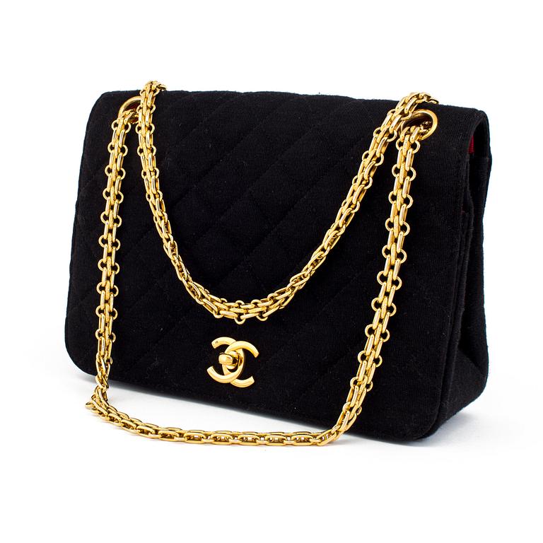 A black quiltet jersey handbag by Chanel.