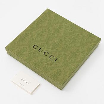 Gucci, a silk scarf.