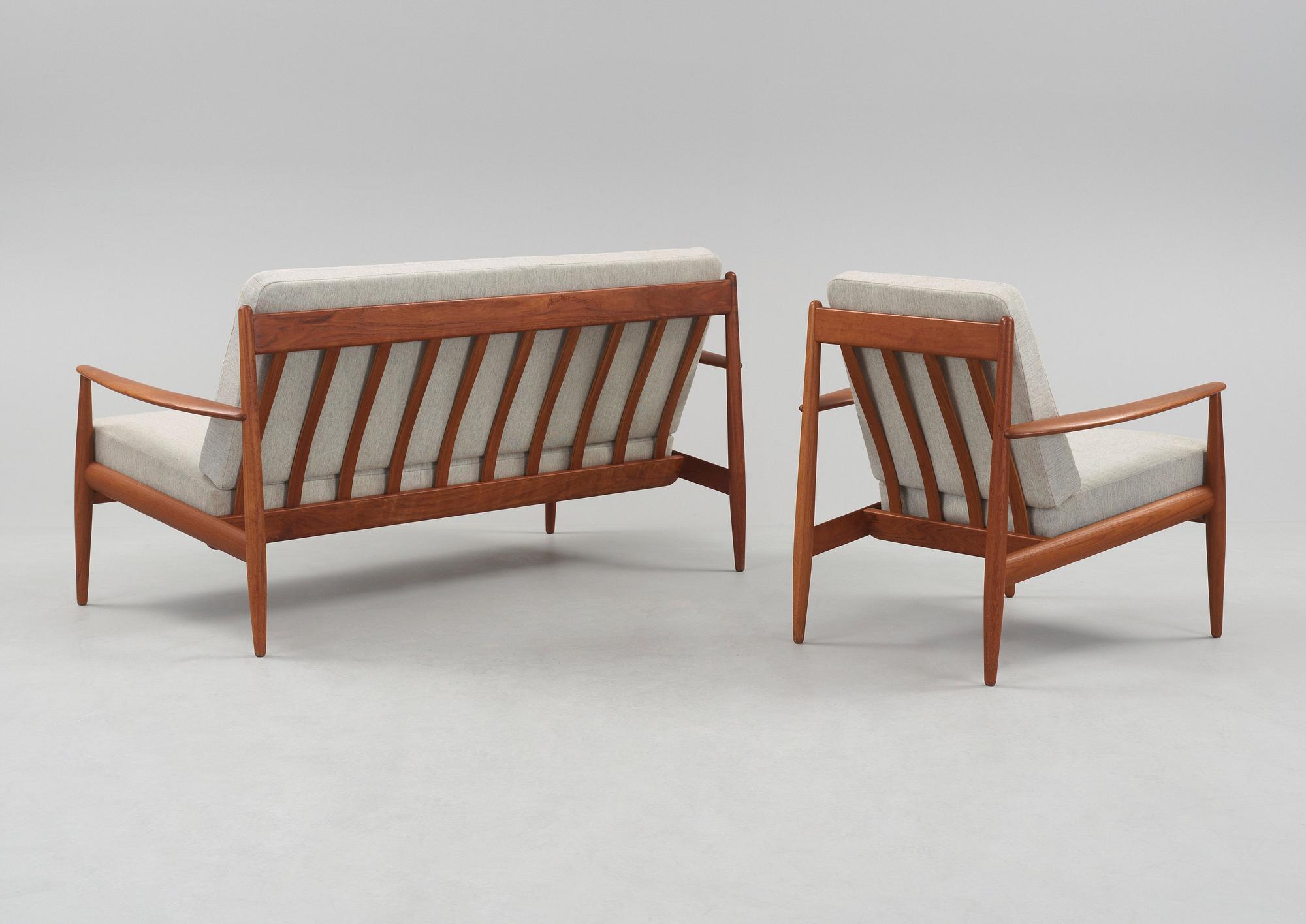 A Grete Jalk teak sofa and armchair, cusions upholstered in grey fabric, France & Daverkosen, Denmark 1960's.