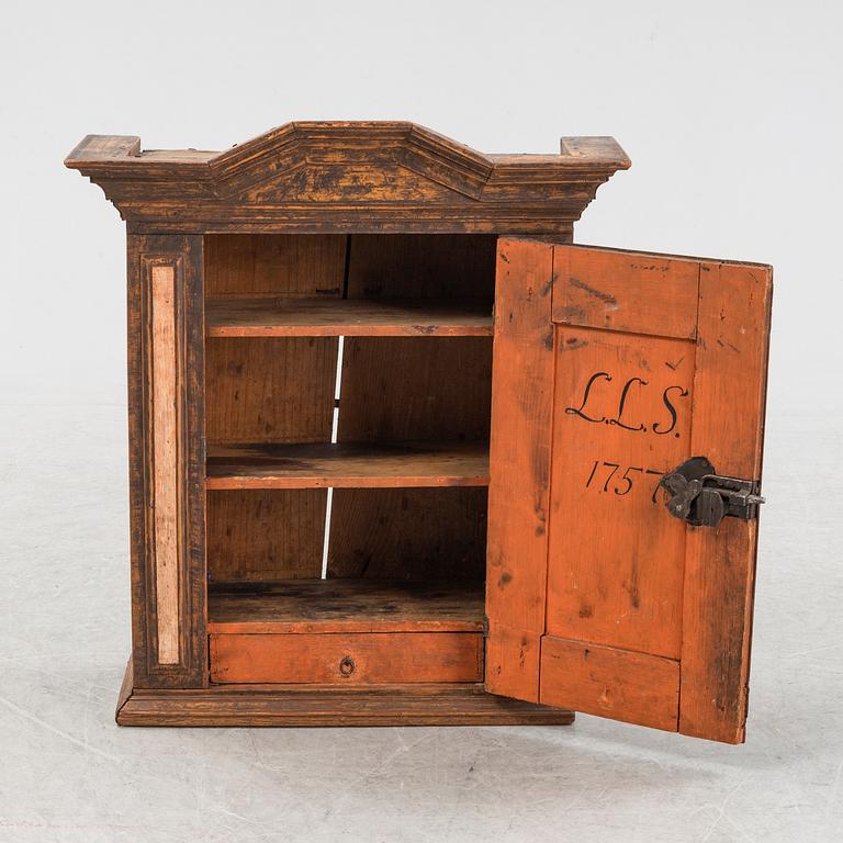 A late Baroque painted wall cabinet, dated 1757.