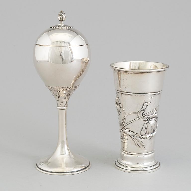 An Art Nouveau parcel-gilt lidded cup and beaker, maker's mark CG Hallberg, Stockholm 1913 and 1900.