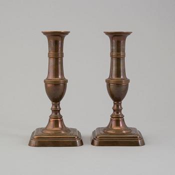 A pair of 19th century bronze candlesticks.