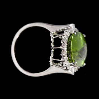 A peridote, 13.16 cts, and brilliant cut diamond ring.