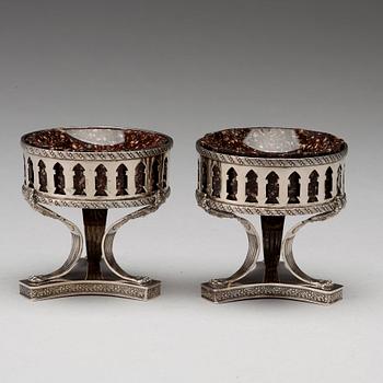 A pair of Swedish 19th century porphyry and silver salt-cellars, silver with mark of Gustaf Folcker, Stockholm 1823.