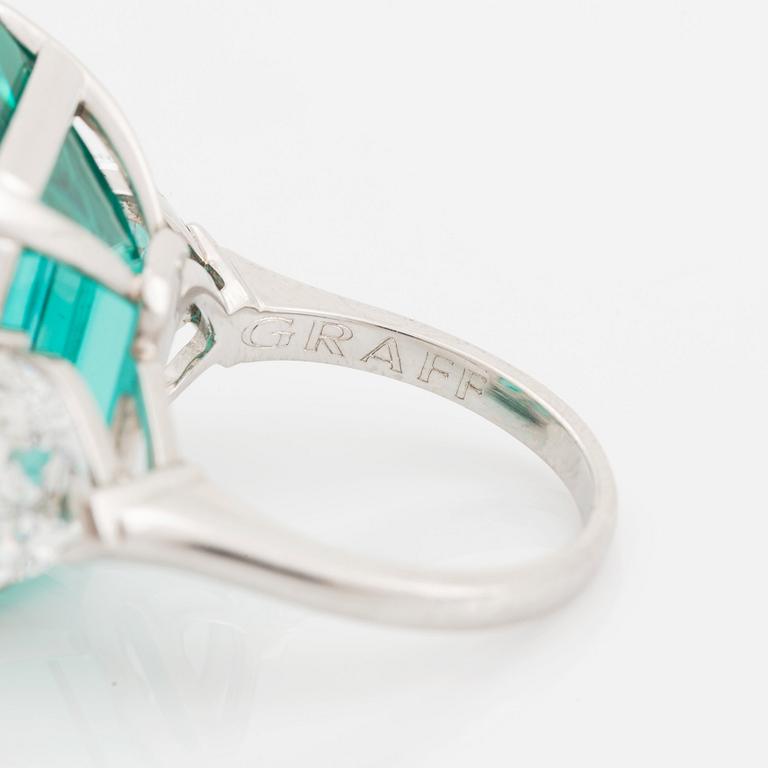 An 18K white gold Graff ring set with a step-cut tourmaline and two heart-cut diamonds.