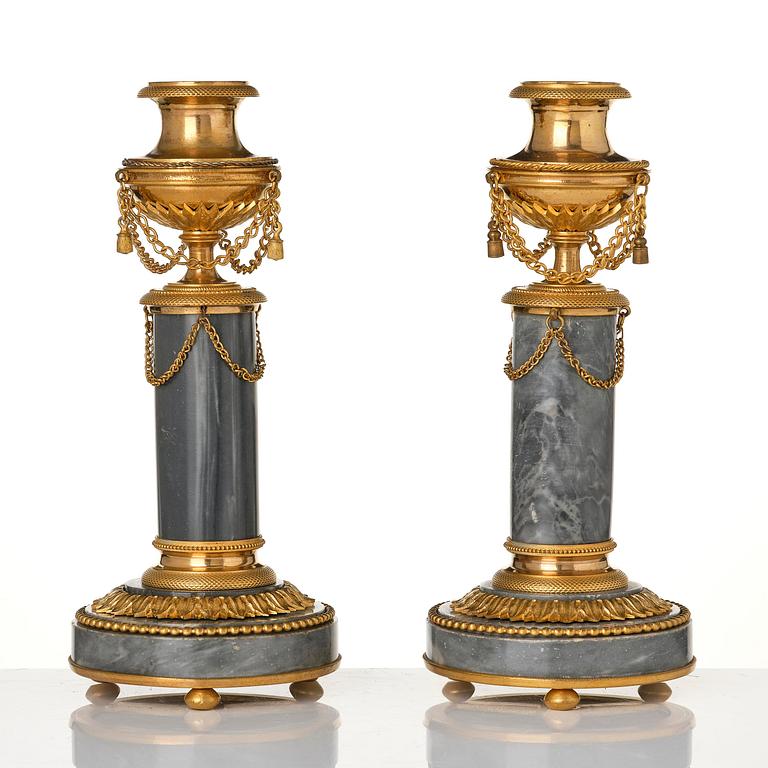 A pair of Louis XVI ormolu and Bleu turquin candlesticks.
