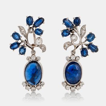 869. A pair of CF Carlman platinum earrings set with cabochon-cut and faceted sapphires.