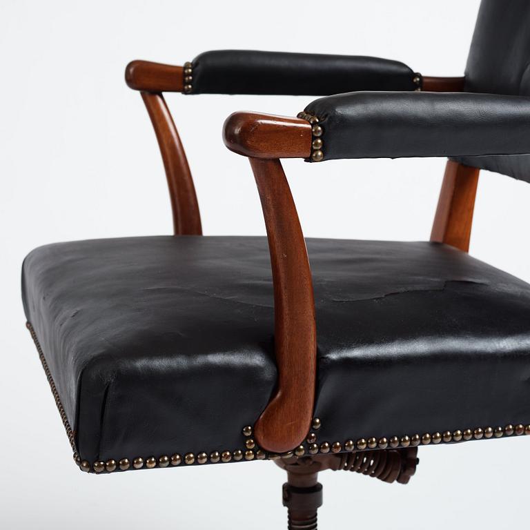 Josef Frank, a mahogany and black leather swivel chair, modified version of model 695, Svenskt Tenn, ca 1956-1957.