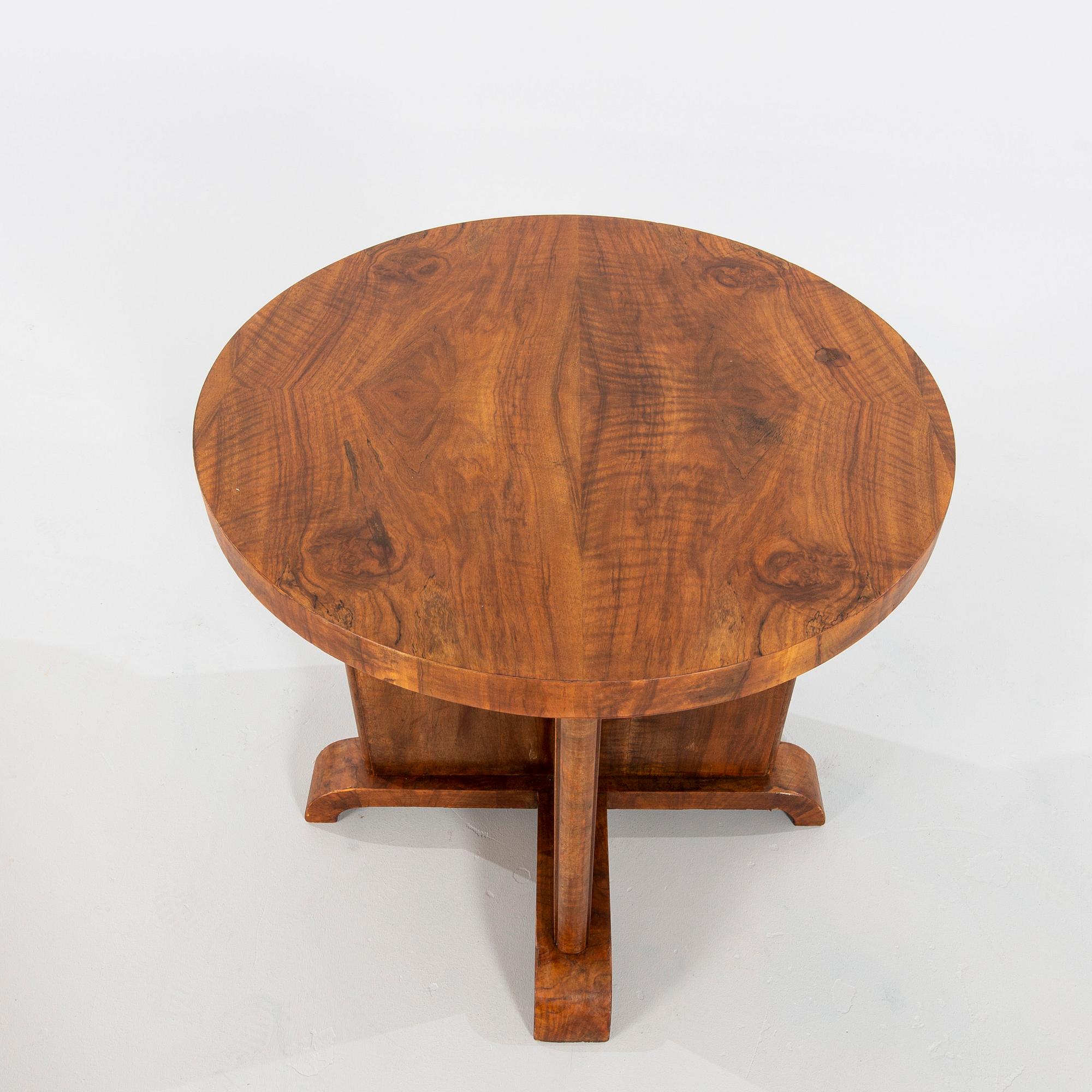 An Art Déco-style walnut table, manufactured in modern times.