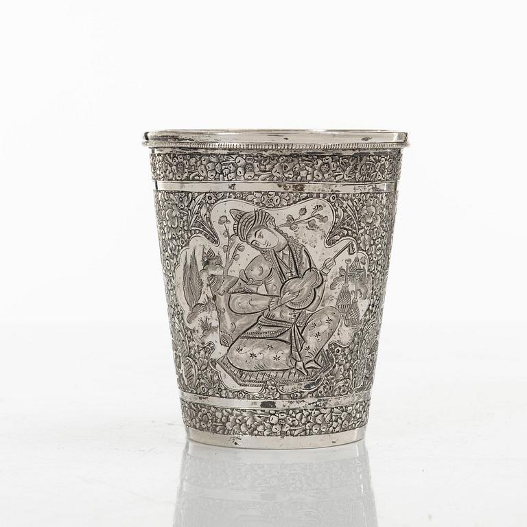 A Persian silver pitcher with five stemmed cups and a beaker, first part of the 1900s.