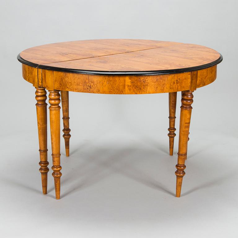 A birch veneered dining table, second half of the 19th Century.