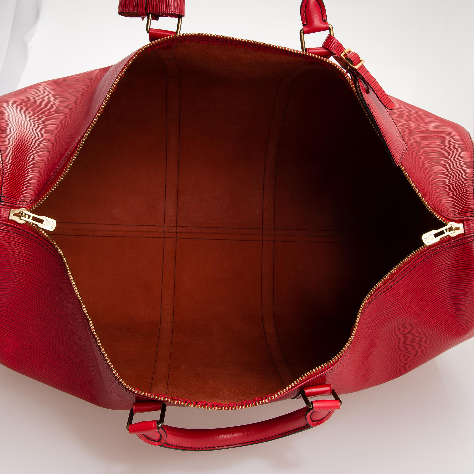 A RED EPI LEATHER KEEPALL TRAVEL BAG.