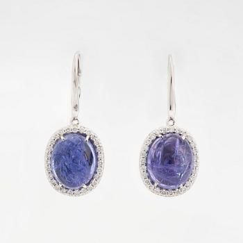 Cabochon-cut tanzanites and diamond earrings.