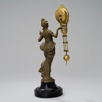 A 1930s Junghans swinger clock with girl sculpture.