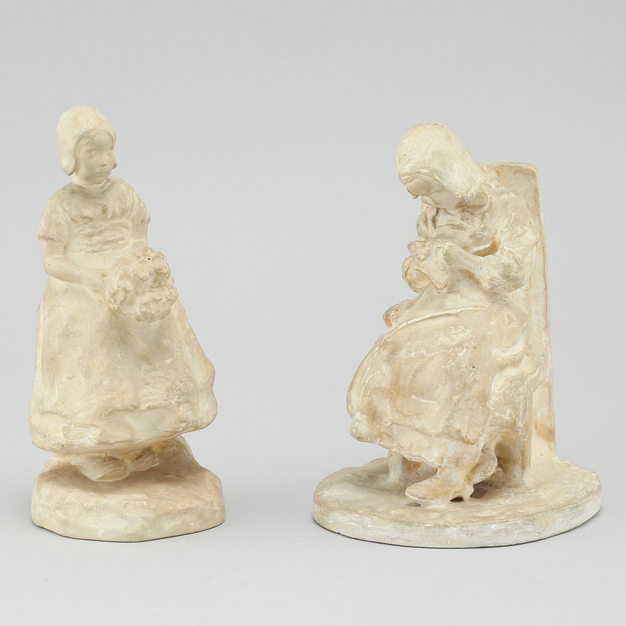 two plaster figurines, signed.