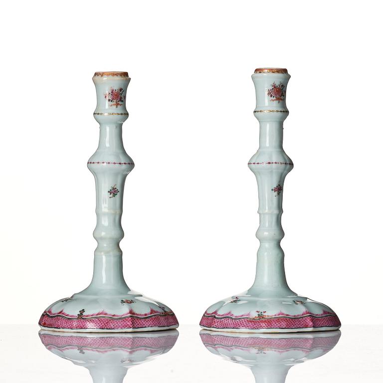 A pair of famille rose candle sticks, Qing dynasty, Qianlong (1736-95).